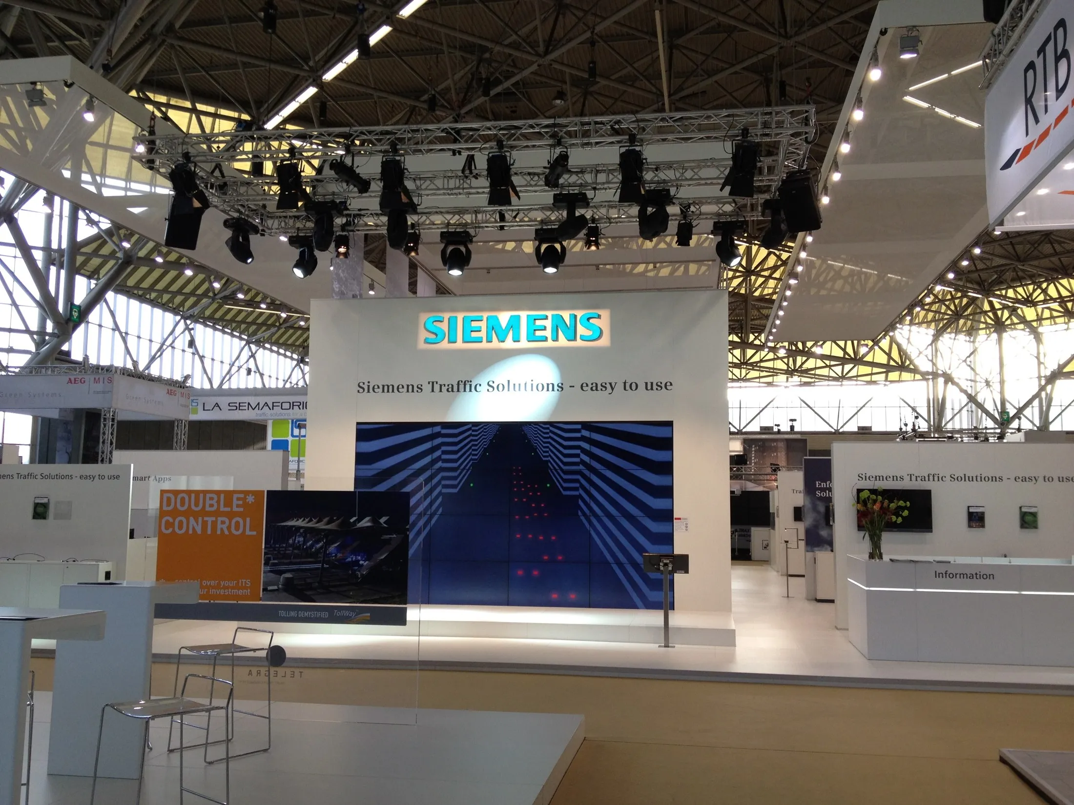 Großer Siemens-Messestand mit beleuchtetem Logo, LED-Wand und Lichttraverse, gebaut von Metronome